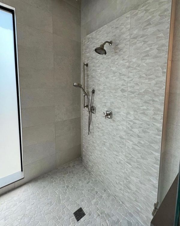 A room with a brick floor and a doorway leading to another room.