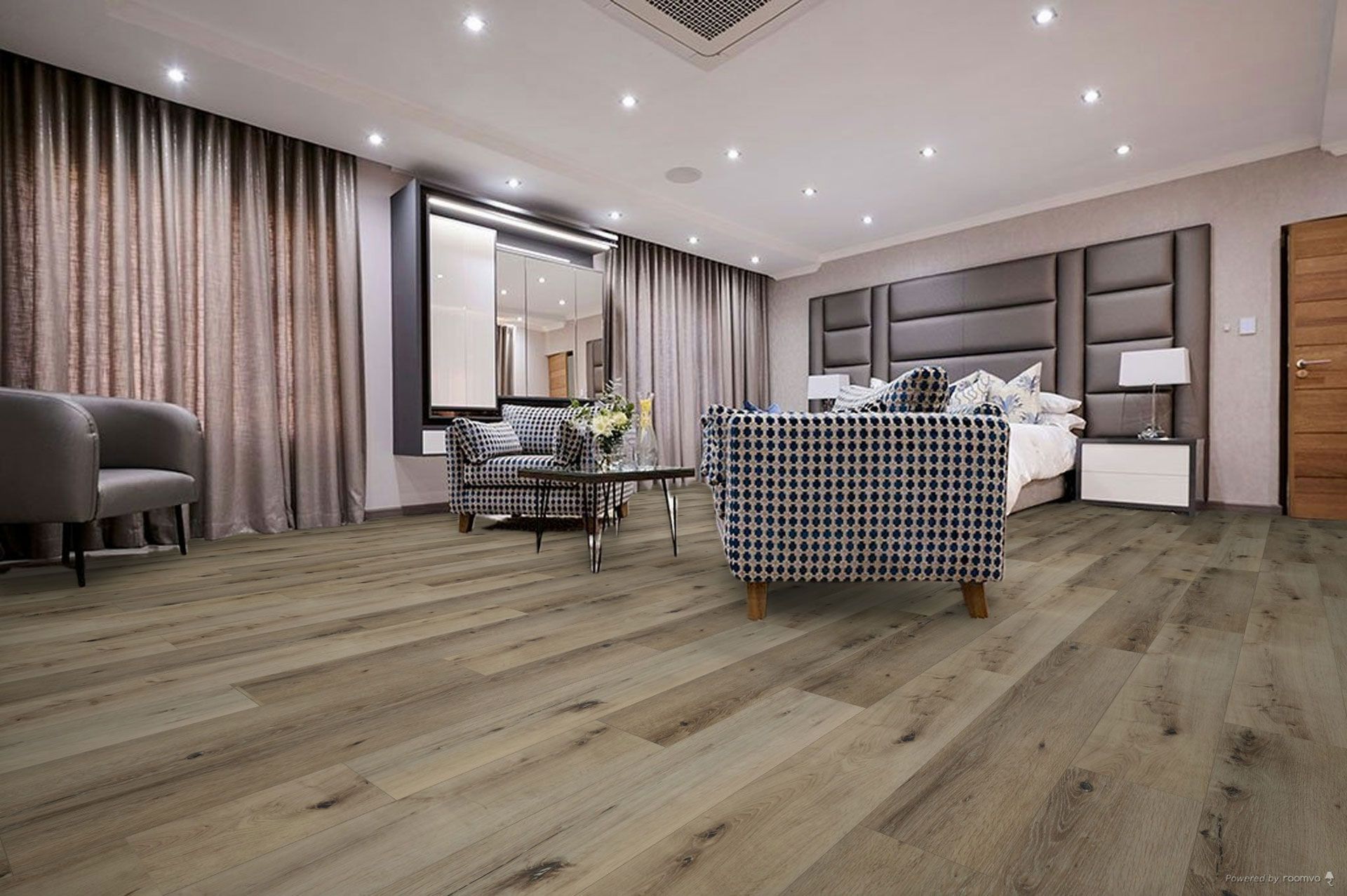 A living room with hardwood floors , a couch , chairs , and a bed.
