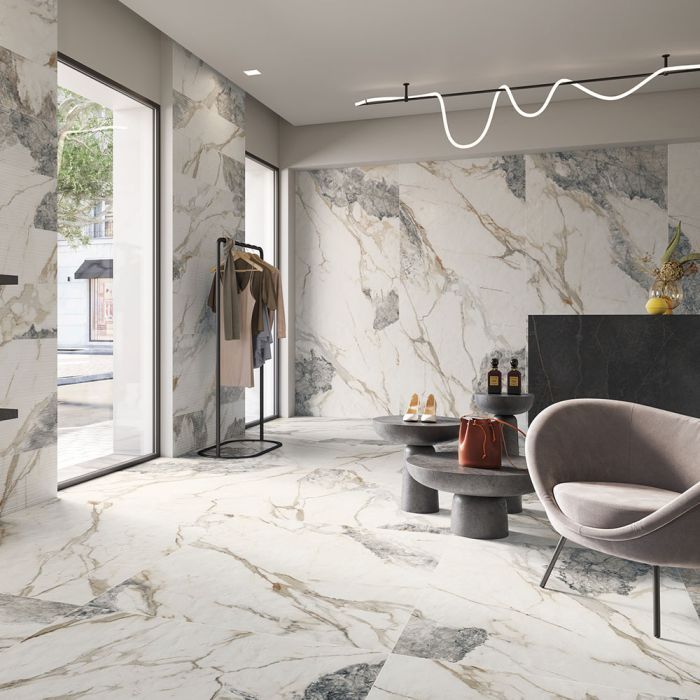 A living room with marble walls and a chair