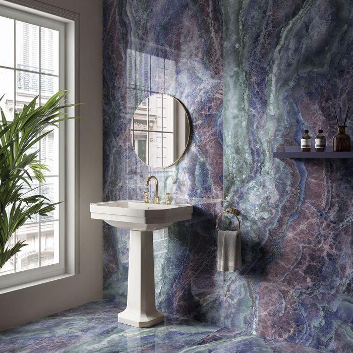 A kitchen with white cabinets and glass doors