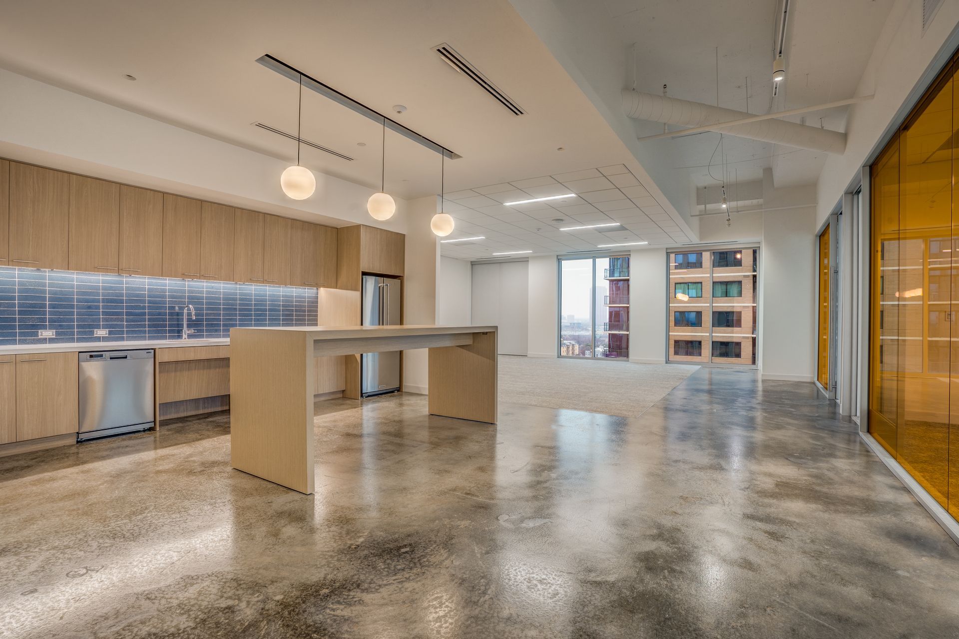 Modern office kitchen with light wood cabinets