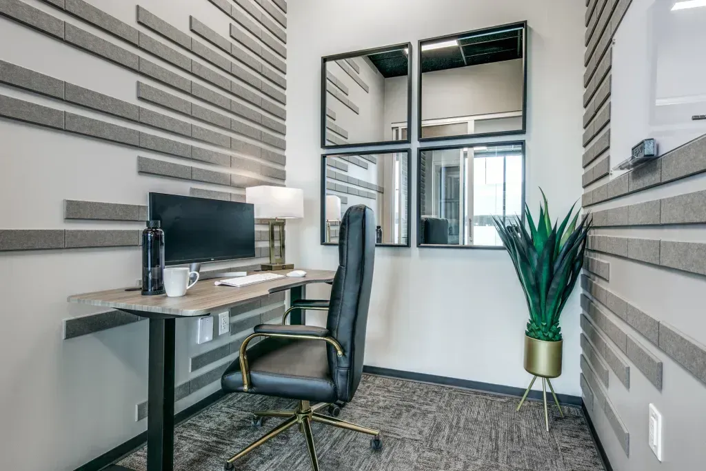 A small office with a desk, chair, and computer.