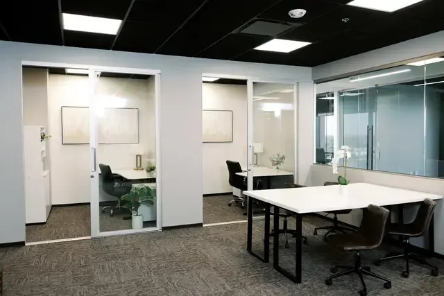 A conference room with tables and chairs in a modern office building.