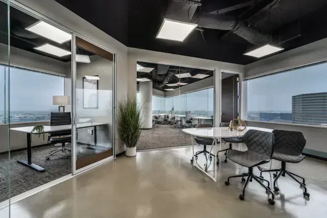There is a conference room with a table and chairs in it.
