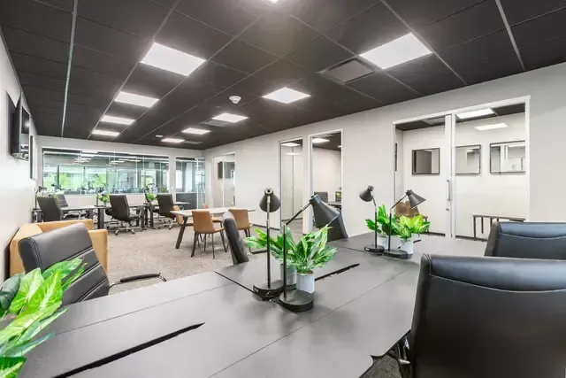 A large room with a table and chairs in it.