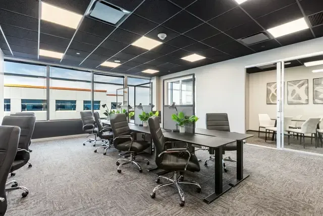 A large conference room with a long table and chairs.