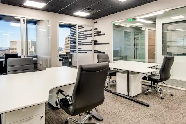 A room with a lot of desks and chairs in it.