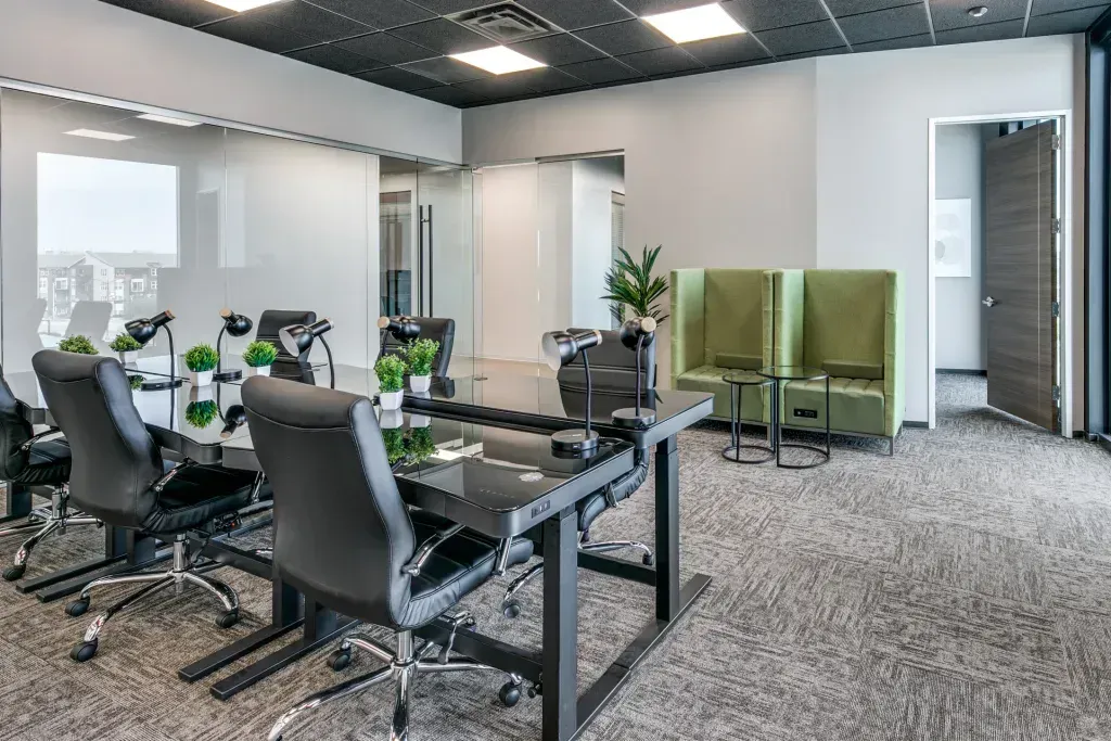 A conference room with a table and chairs in it.