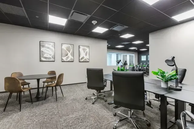 A room with a lot of chairs and tables in it.