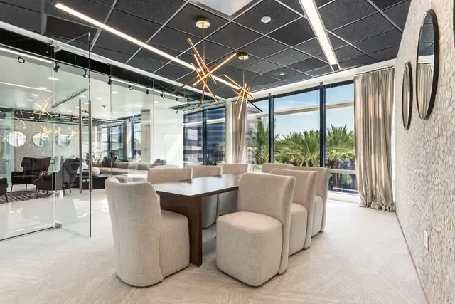 A conference room with a table and chairs in it.