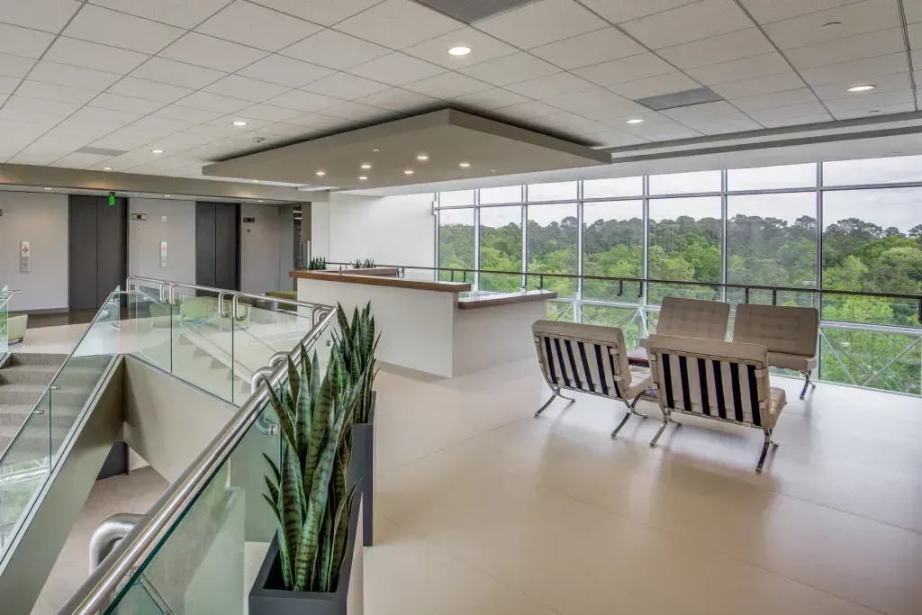 A large room with a lot of windows and a balcony.