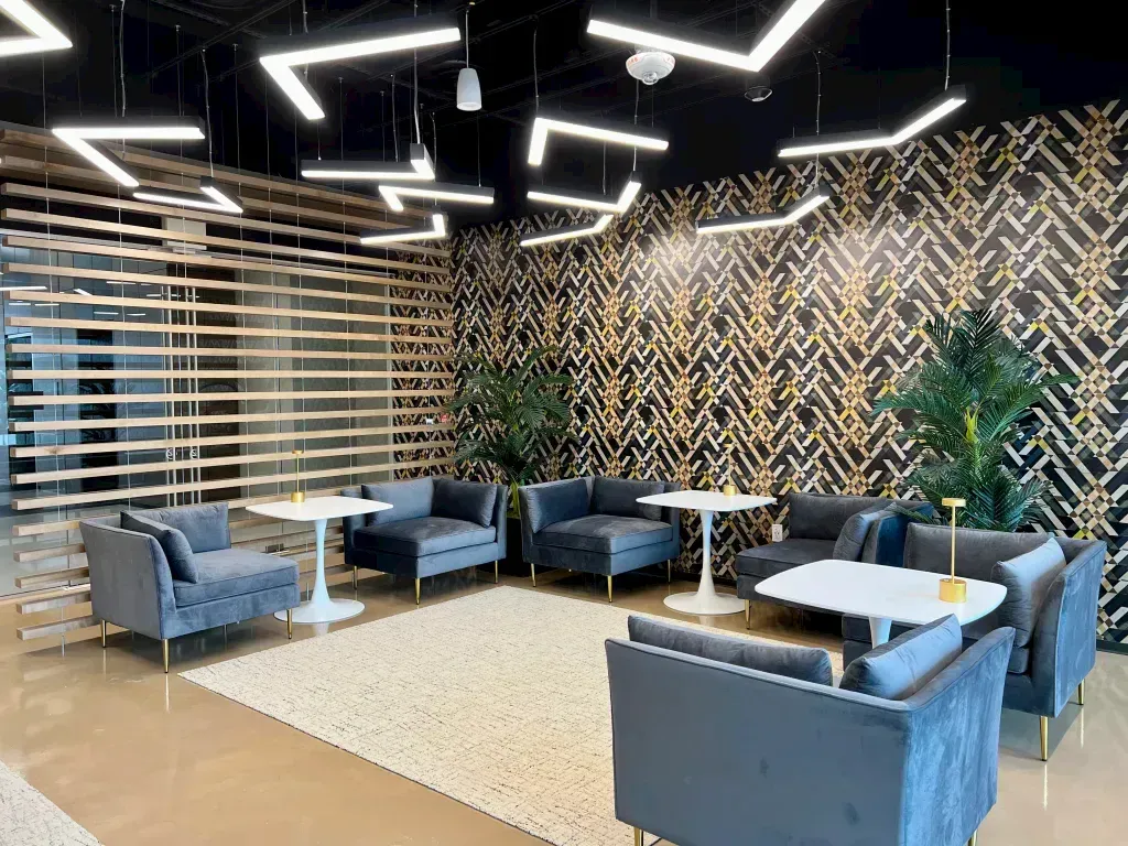 A living room with a lot of furniture and tables.