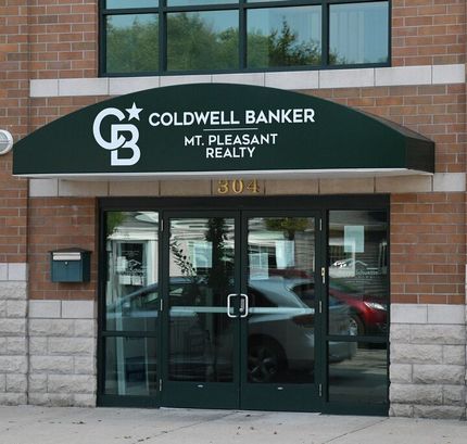 Coldwell Banker Mt. Pleasant Realty storefront with glass doors and green awning