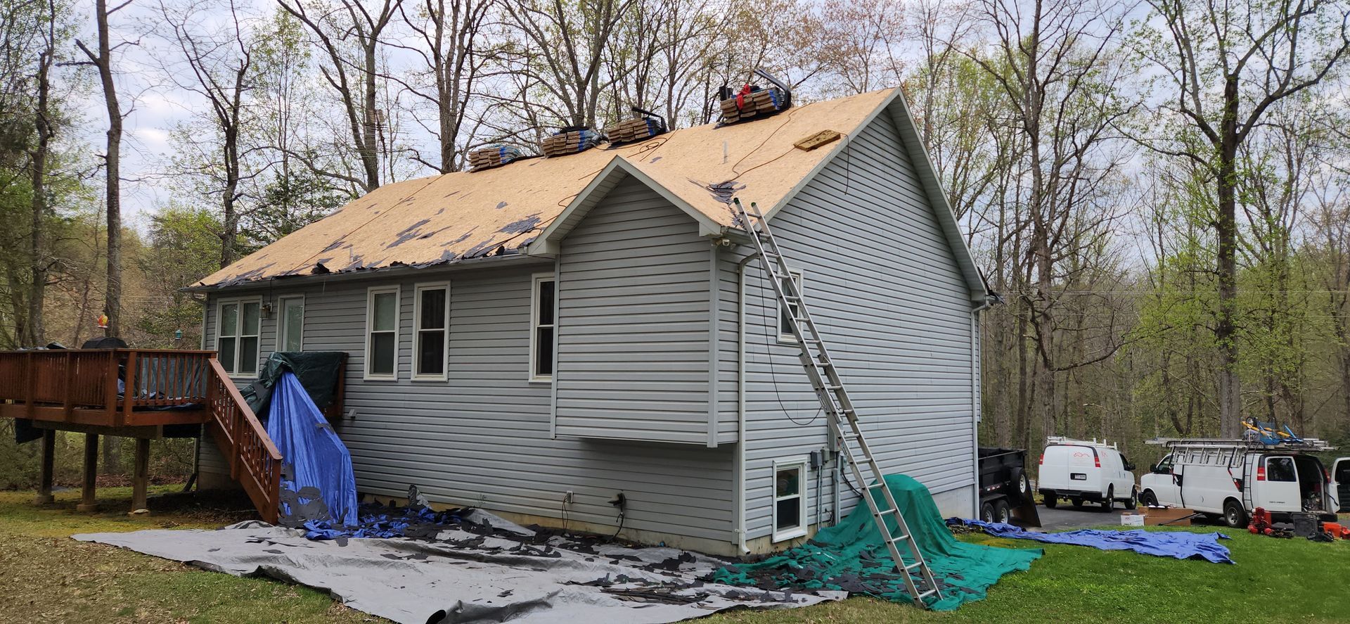 A house is being remodeled with a roof being installed.