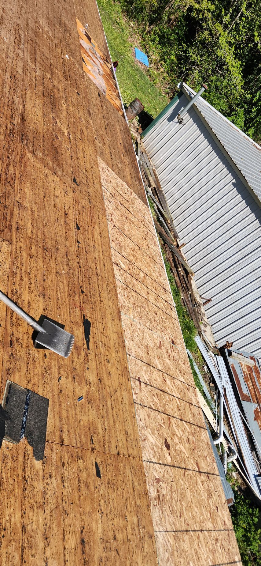 A shovel is sitting on top of a wooden roof.