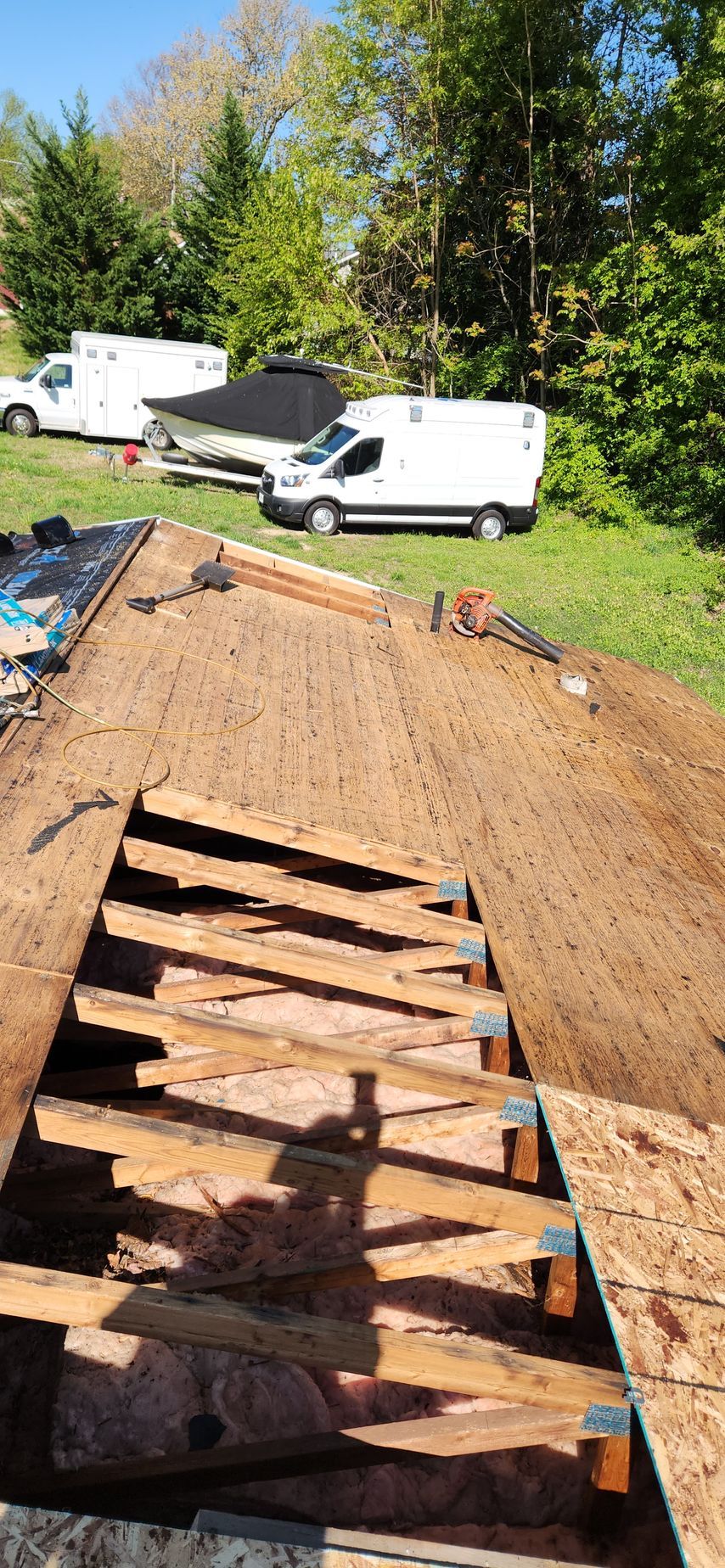 A wooden deck is being built on top of a dirt field.
