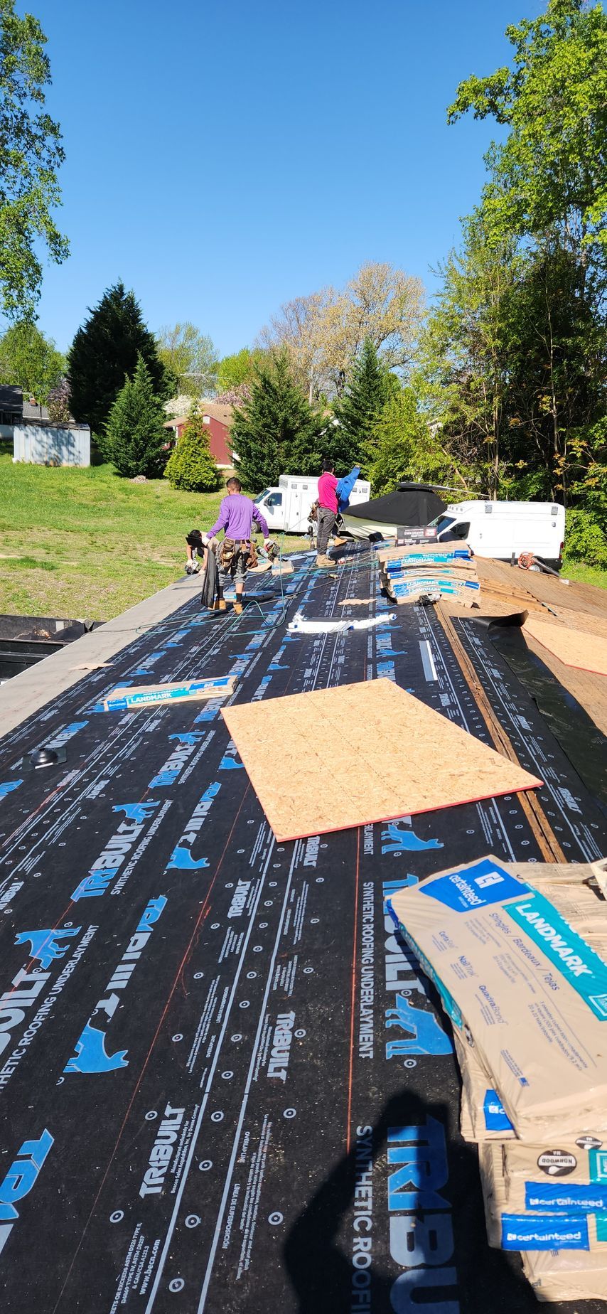 A group of people are working on a roof.