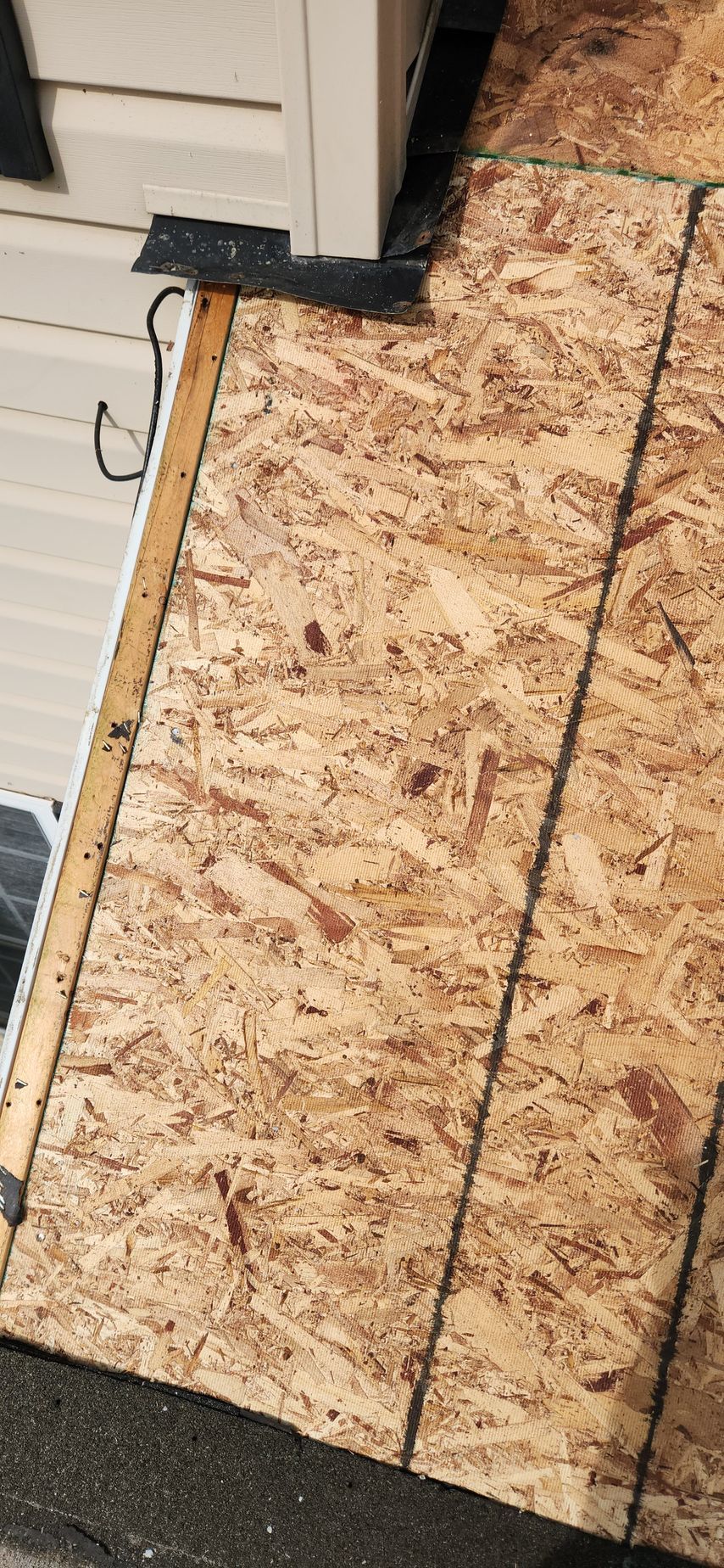 A close up of a piece of plywood on a roof.