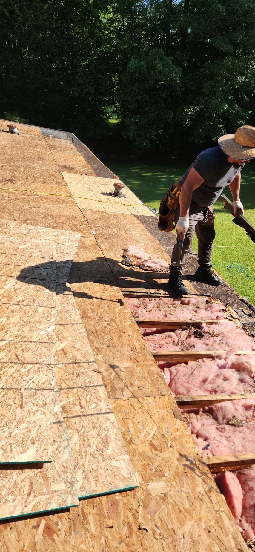 A man is working on the roof of a house.