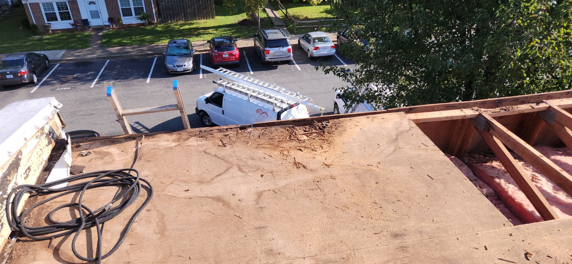 A white van is parked on the roof of a building.
