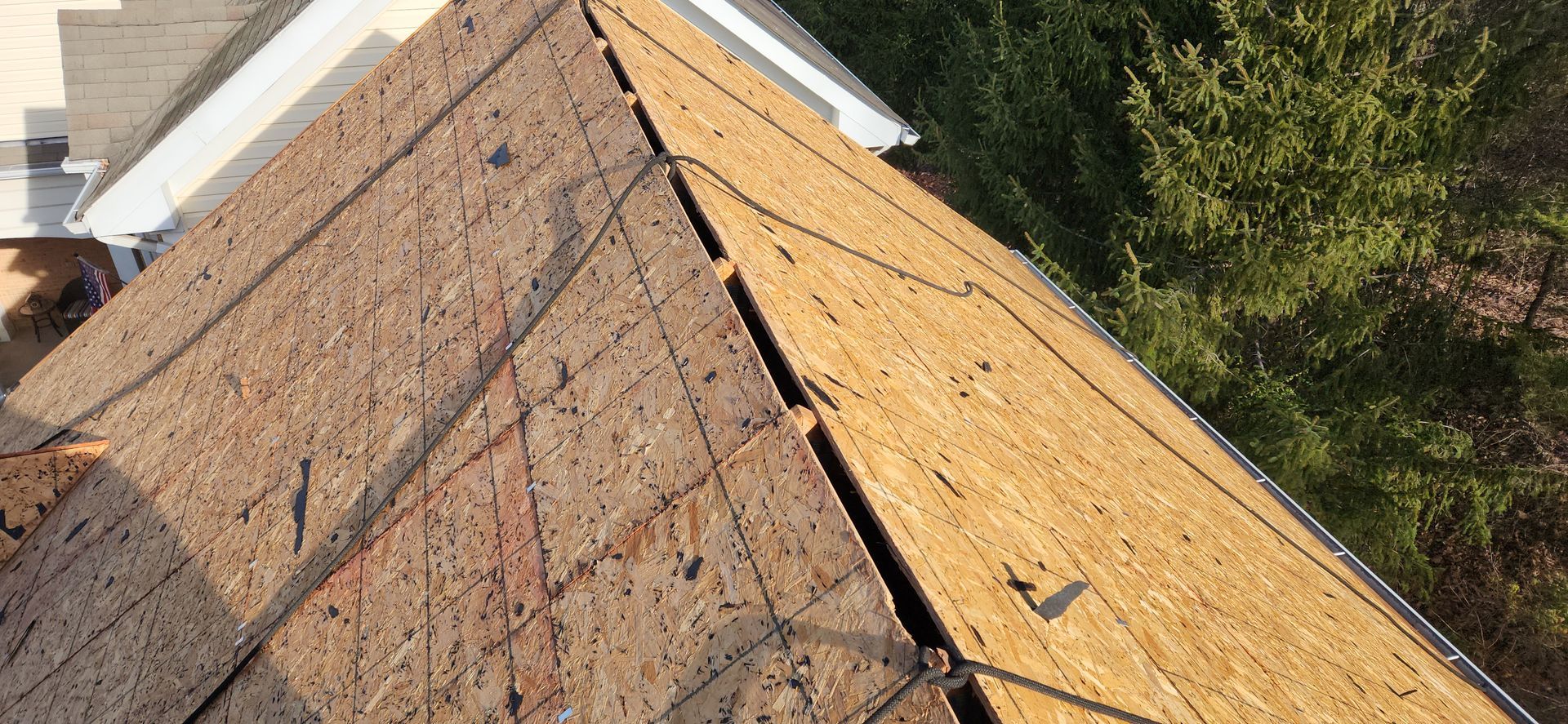 A close up of a roof with shingles being installed.