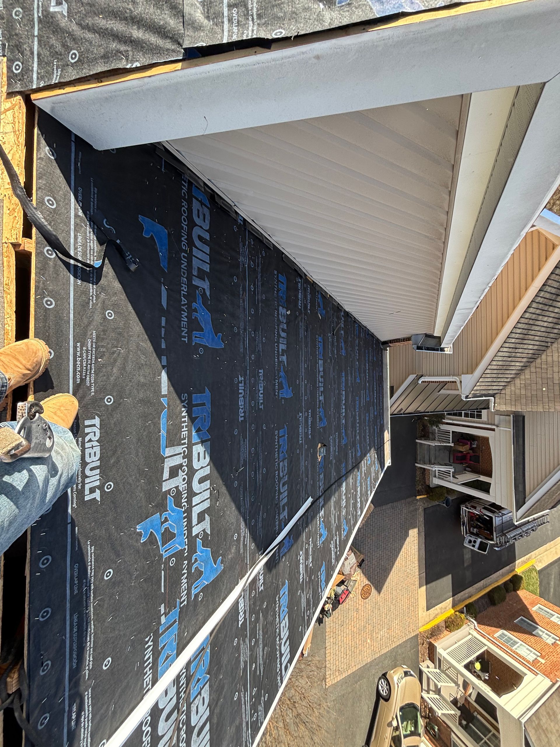 An aerial view of a roof being installed on a house.