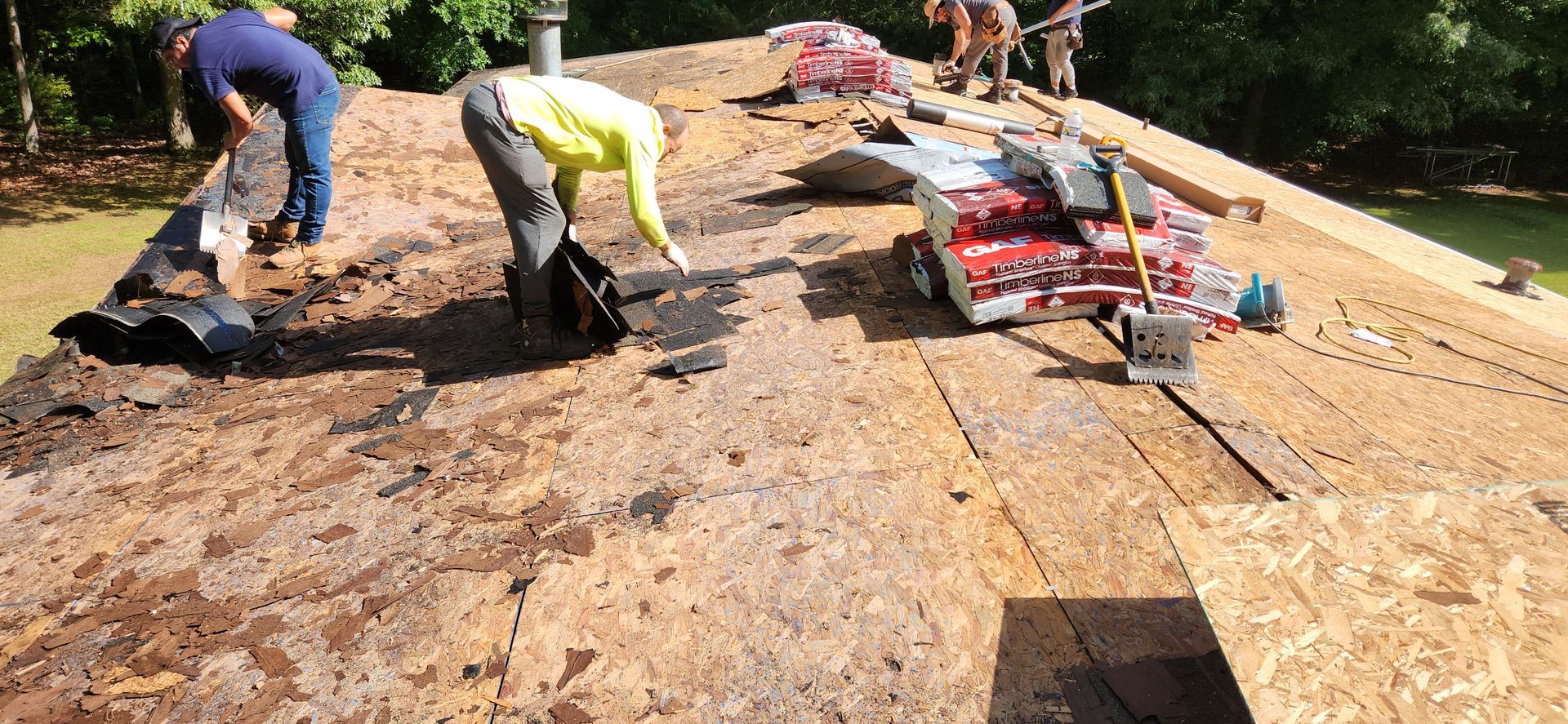A group of people are working on a roof.