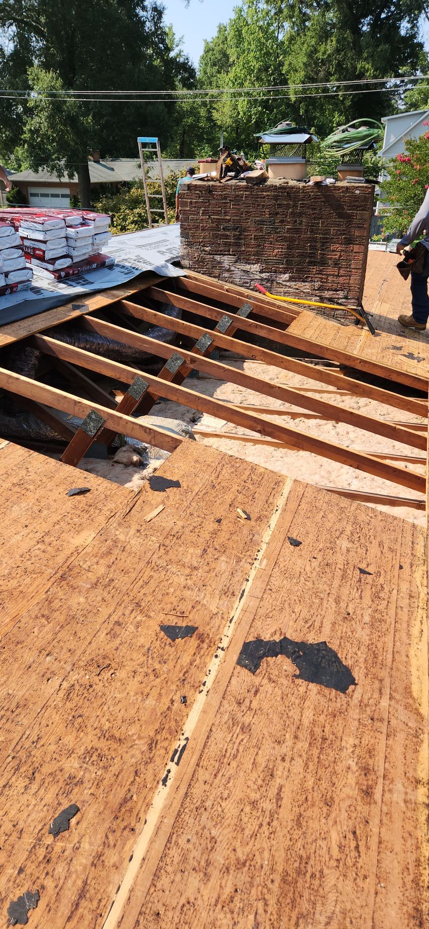 A man is working on the roof of a house.