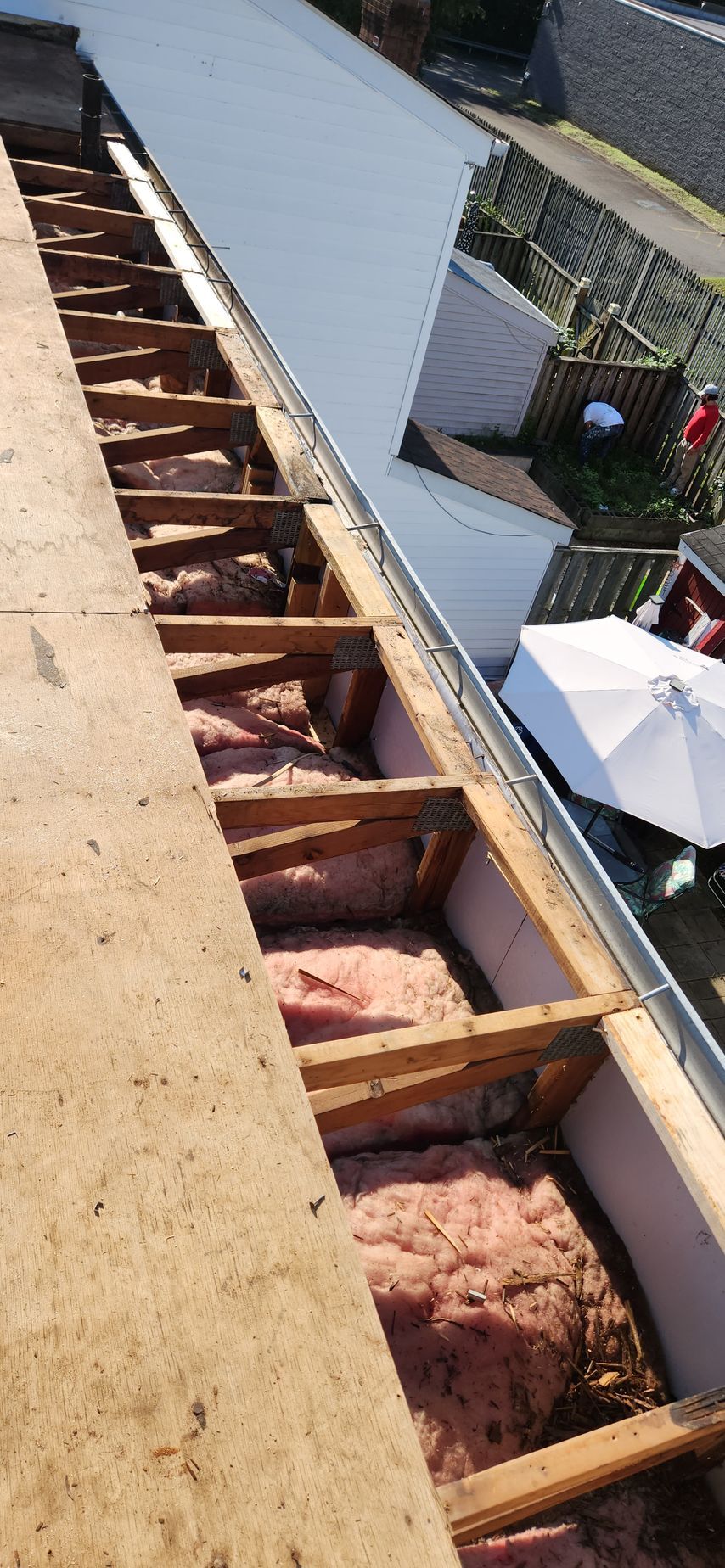 A roof with a lot of wood and insulation on it.