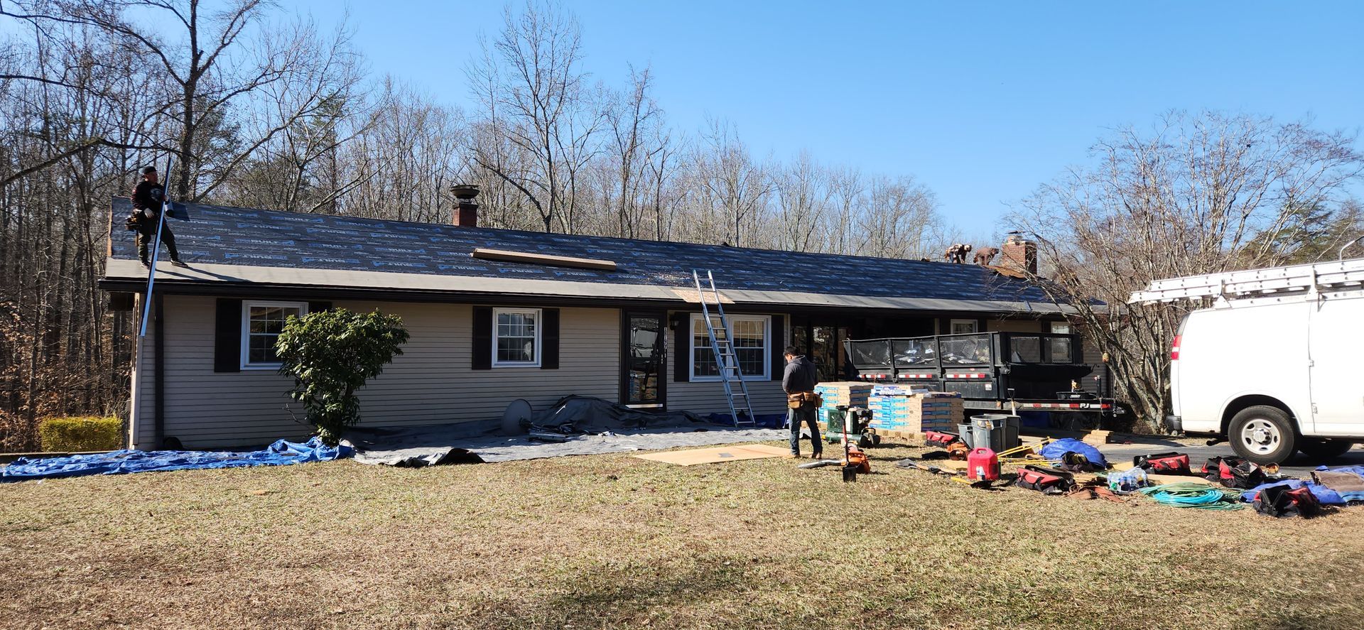A man is working on the roof of a house.
