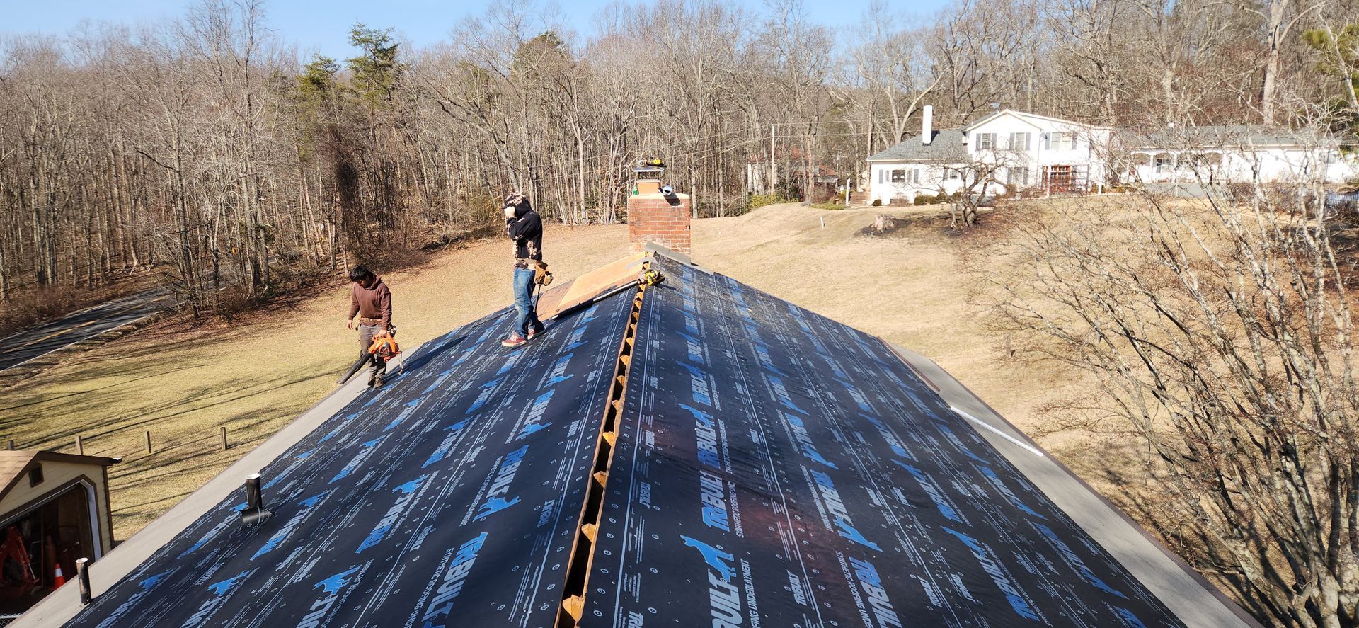 A group of people are working on a roof.