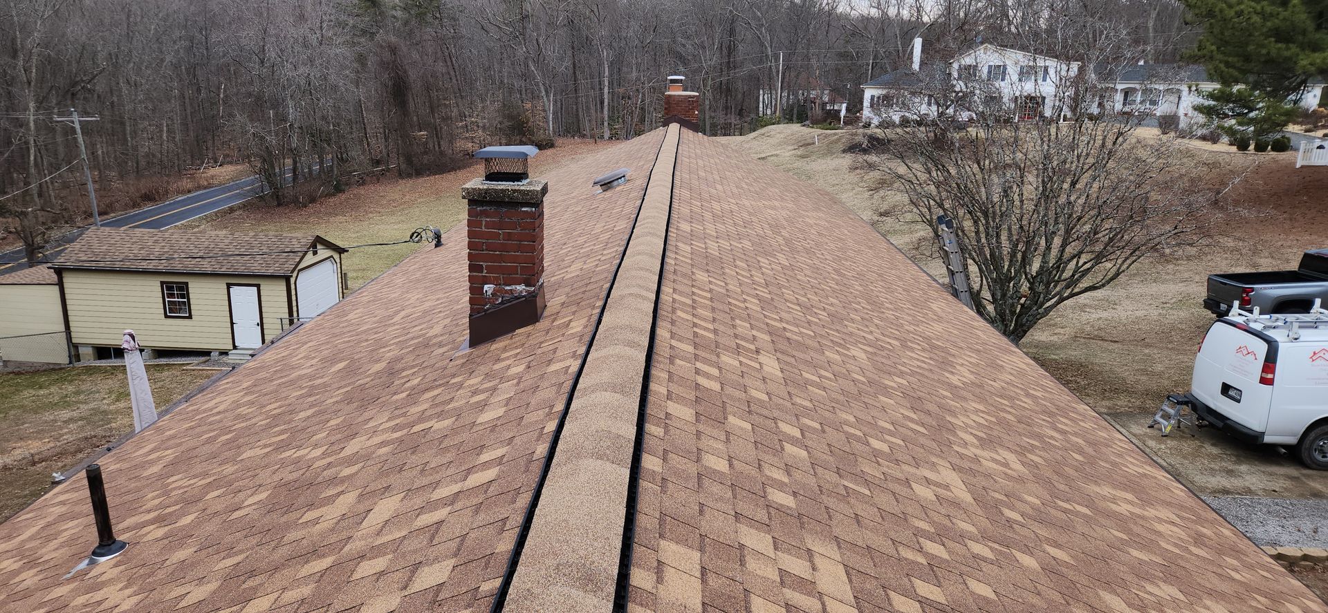 A roof with a chimney and a truck parked on it.