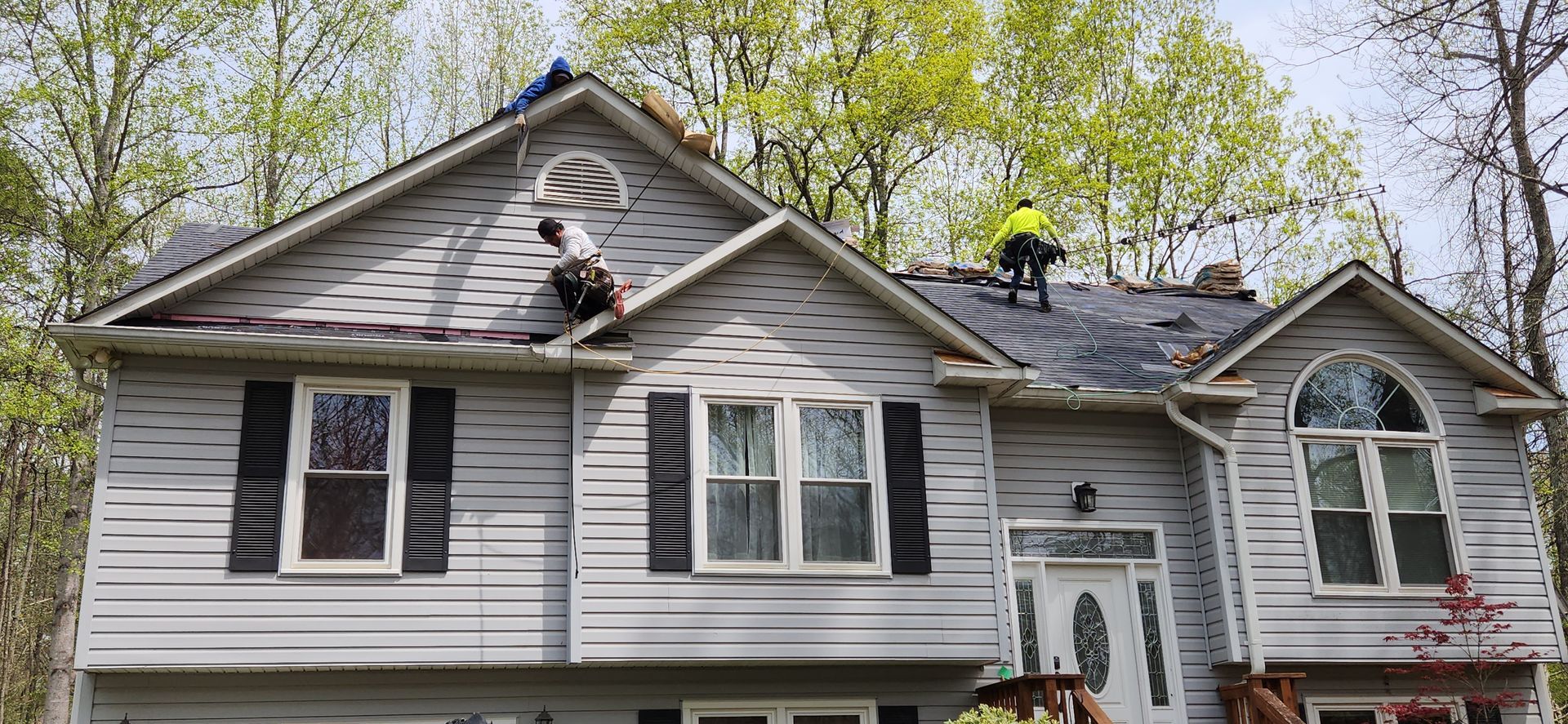 A man is working on the roof of a house.