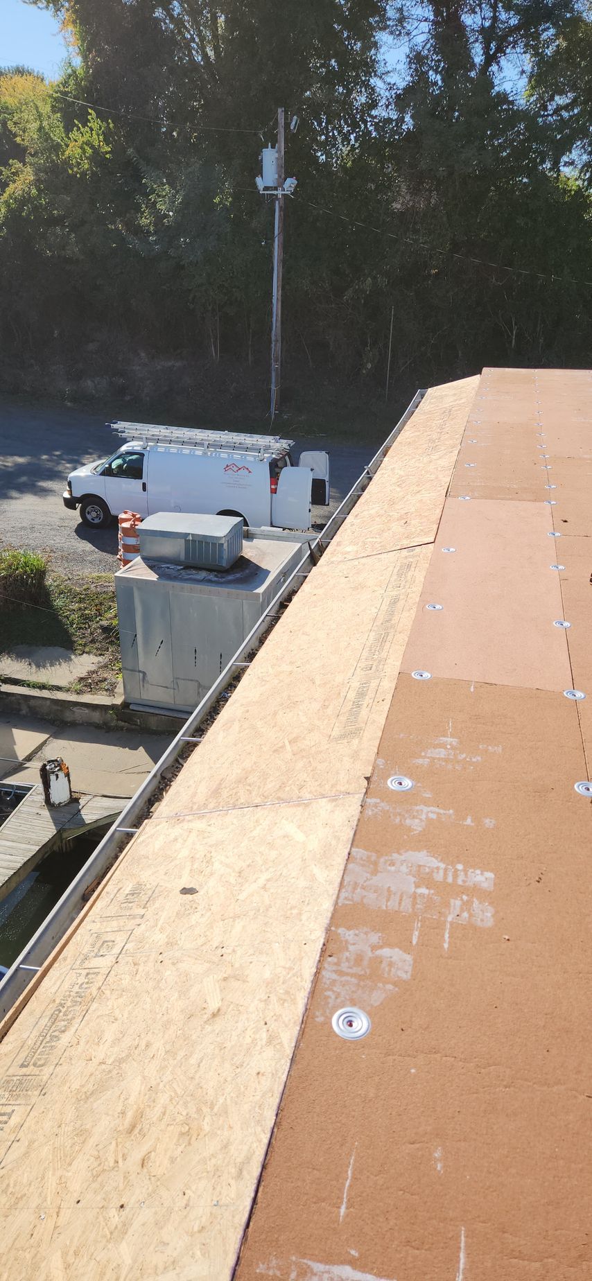 A white van is parked on the roof of a building.
