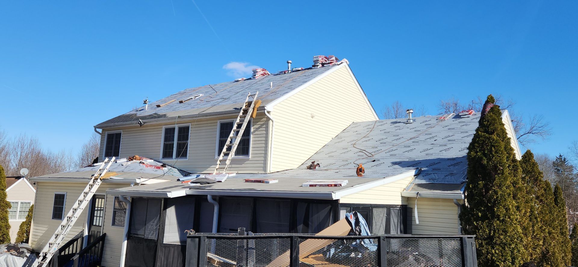 A large house with a roof that is being remodeled.