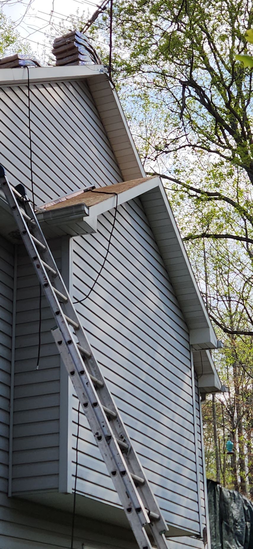 A ladder is attached to the side of a house.
