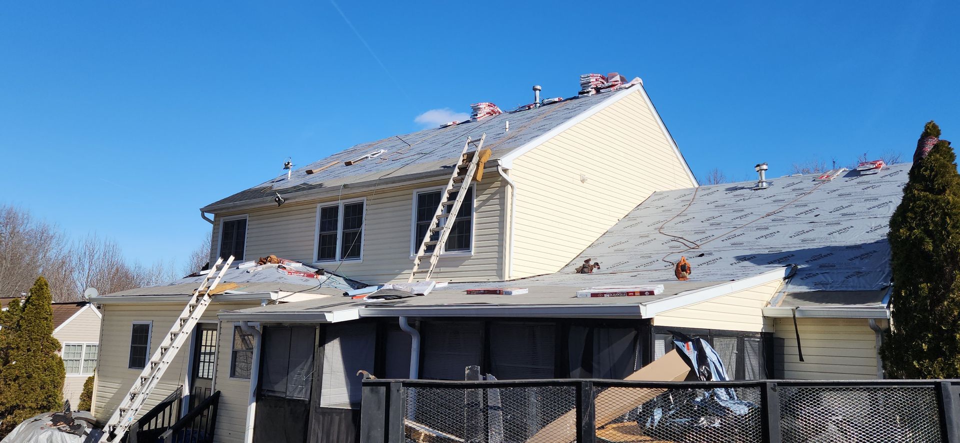 A large house with a roof that is being repaired.