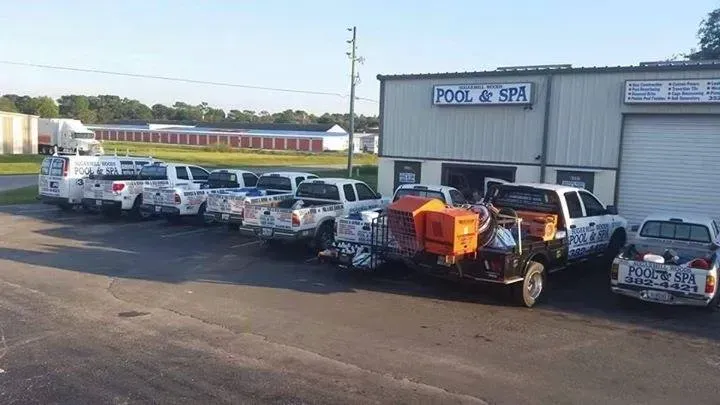 Pool & Spa business with several work trucks parked outside of its building.