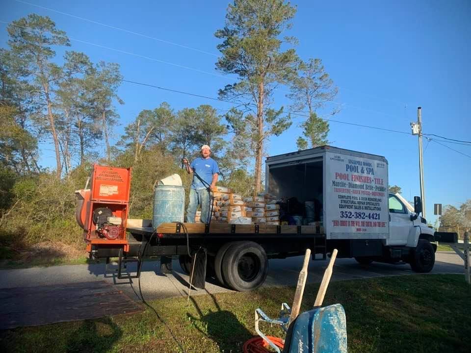 Man loading materials from a truck labeled 