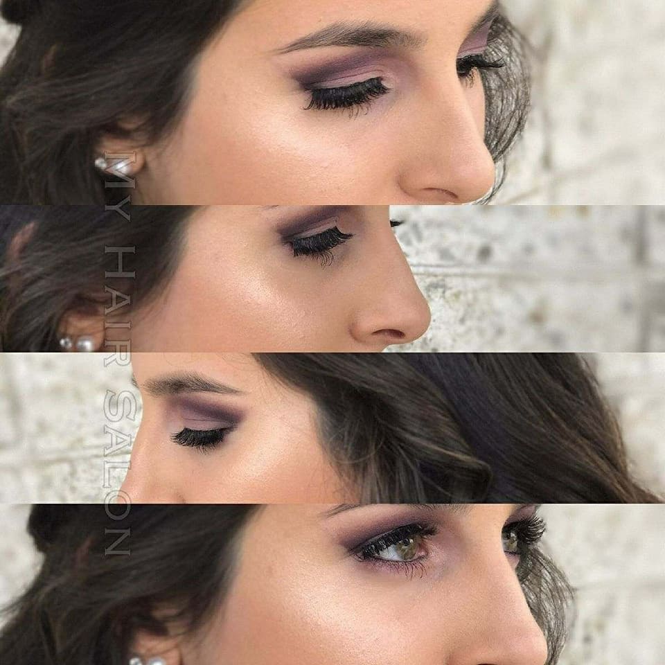 A close up of a woman 's face with purple eyeshadow