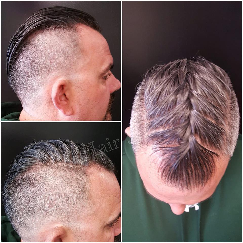 A man with a braided hairstyle and a shaved head