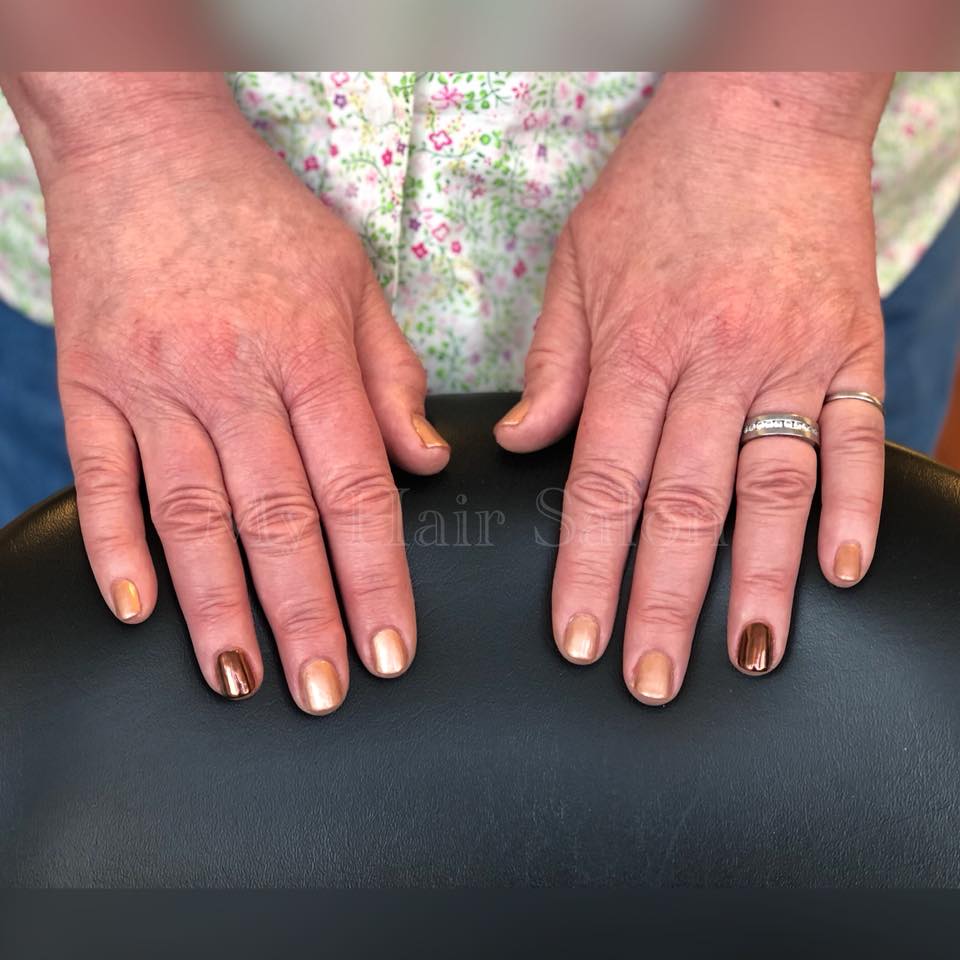 A close up of a person 's hands with rings on their fingers.