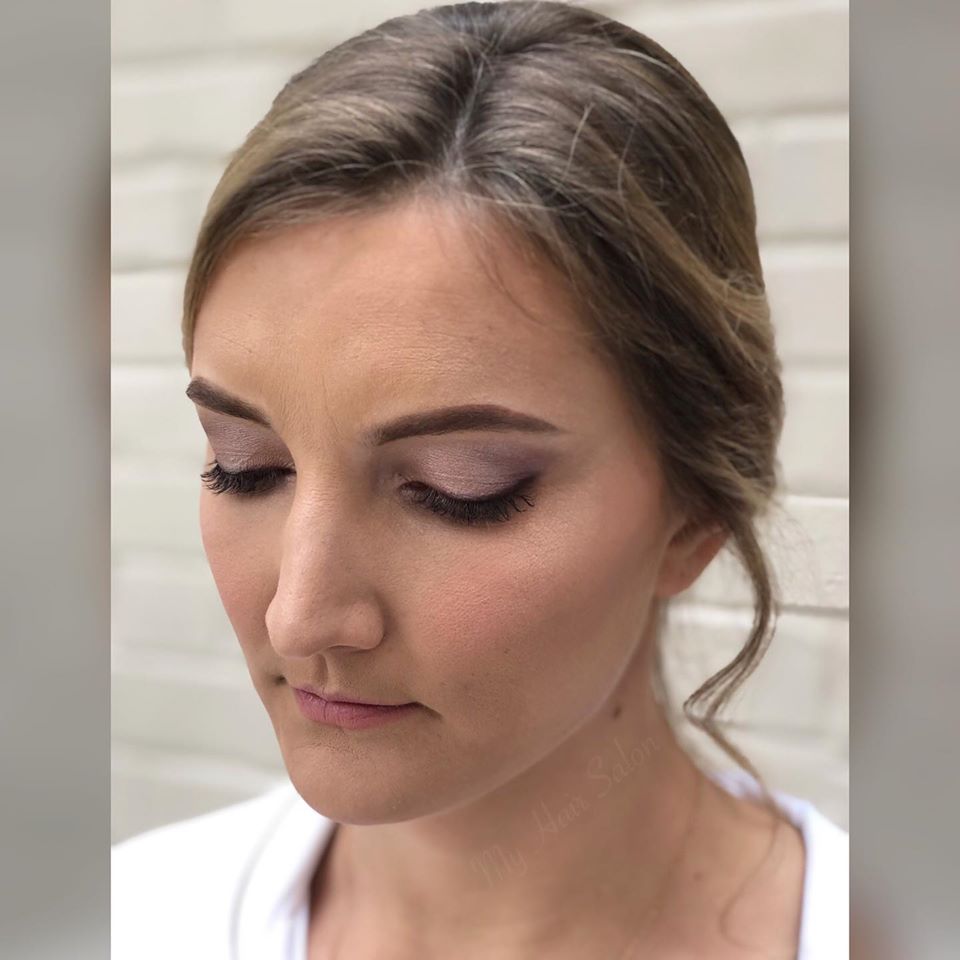 A close up of a woman 's face with makeup on.