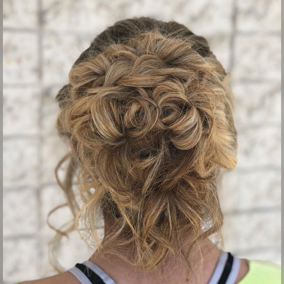 The back of a woman 's head with her hair in a messy bun