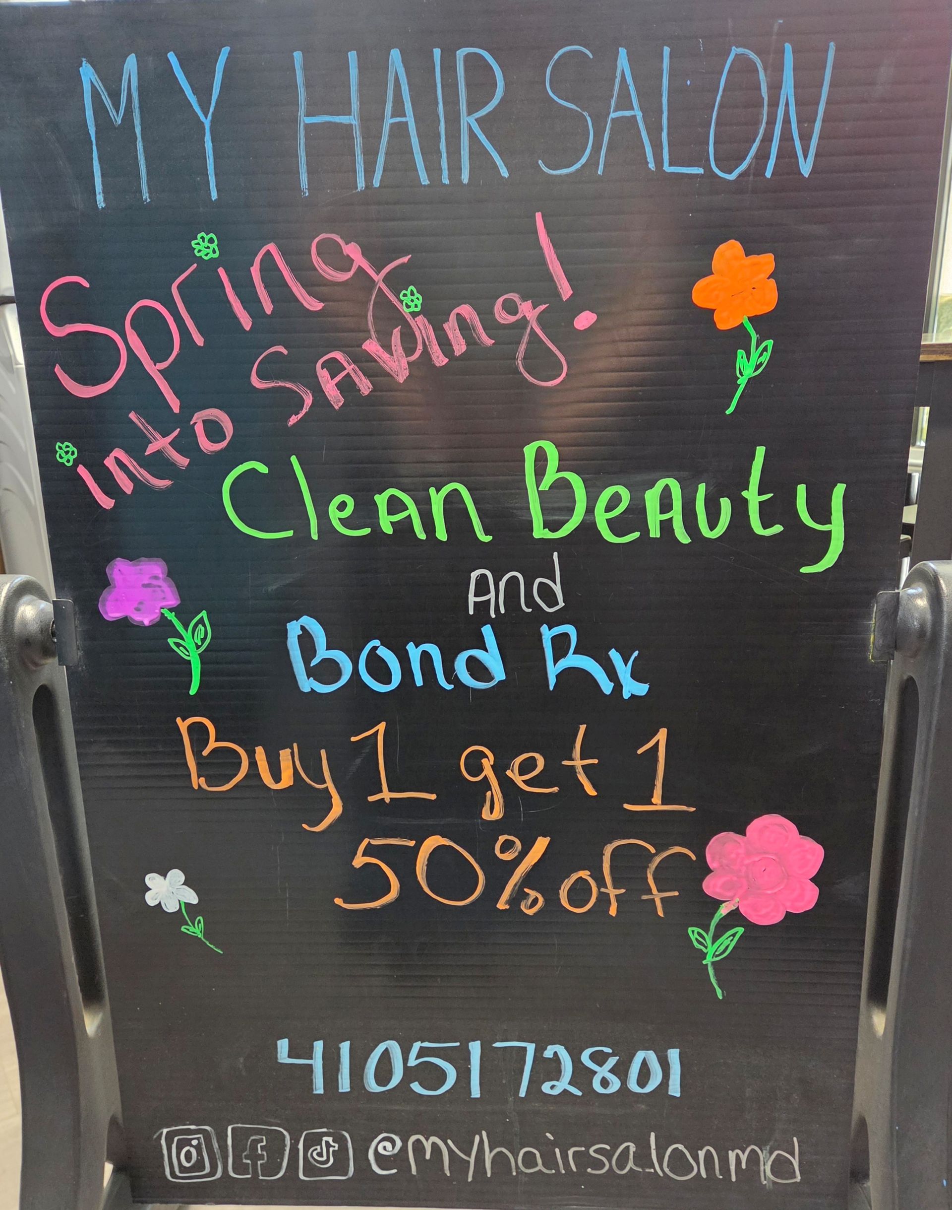 A chalkboard sign at My Hair Salon advertising a