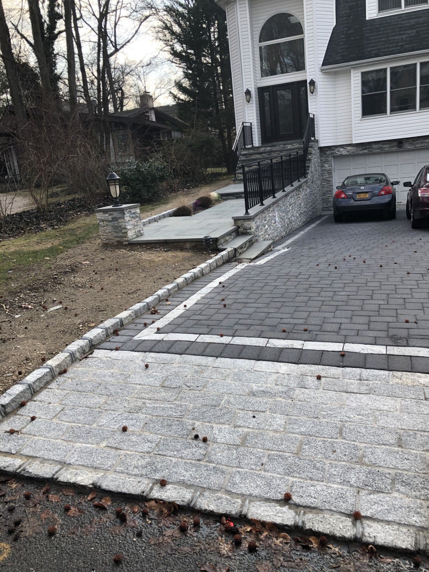 A car is parked in a driveway in front of a house.