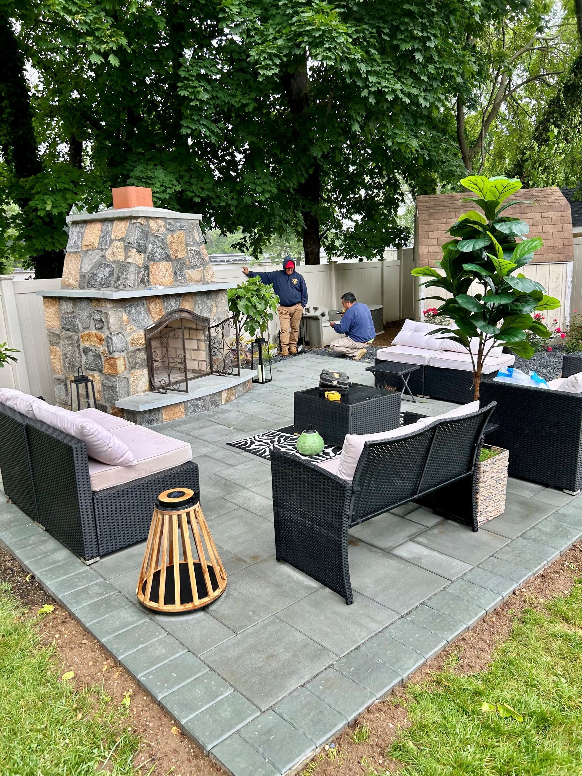 There is a fireplace in the middle of the patio.