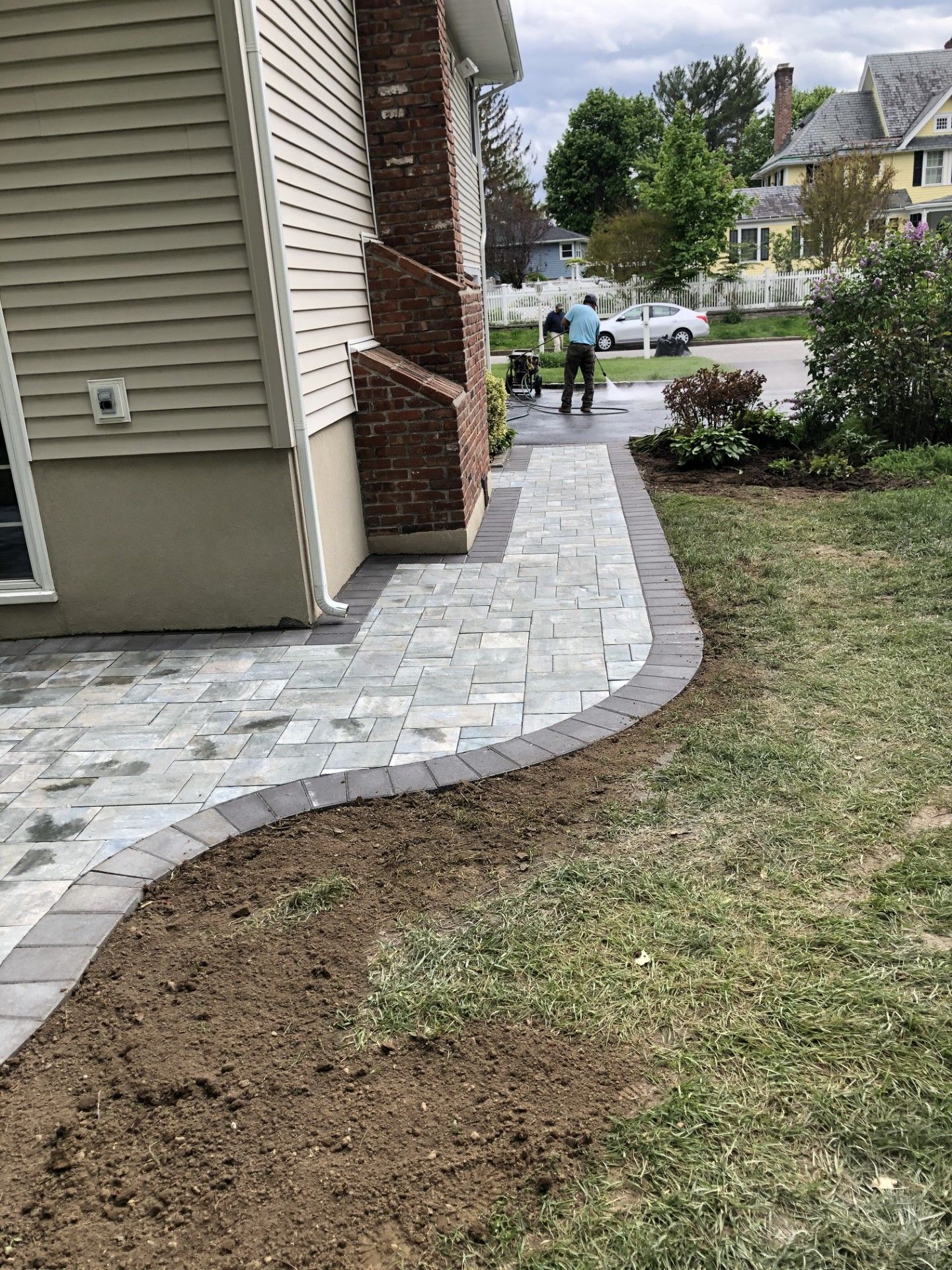 A sidewalk is being built in front of a house.