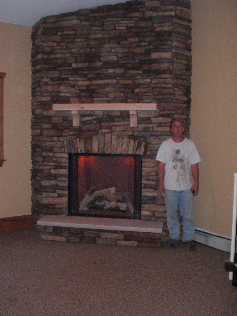 man by tile fireplace