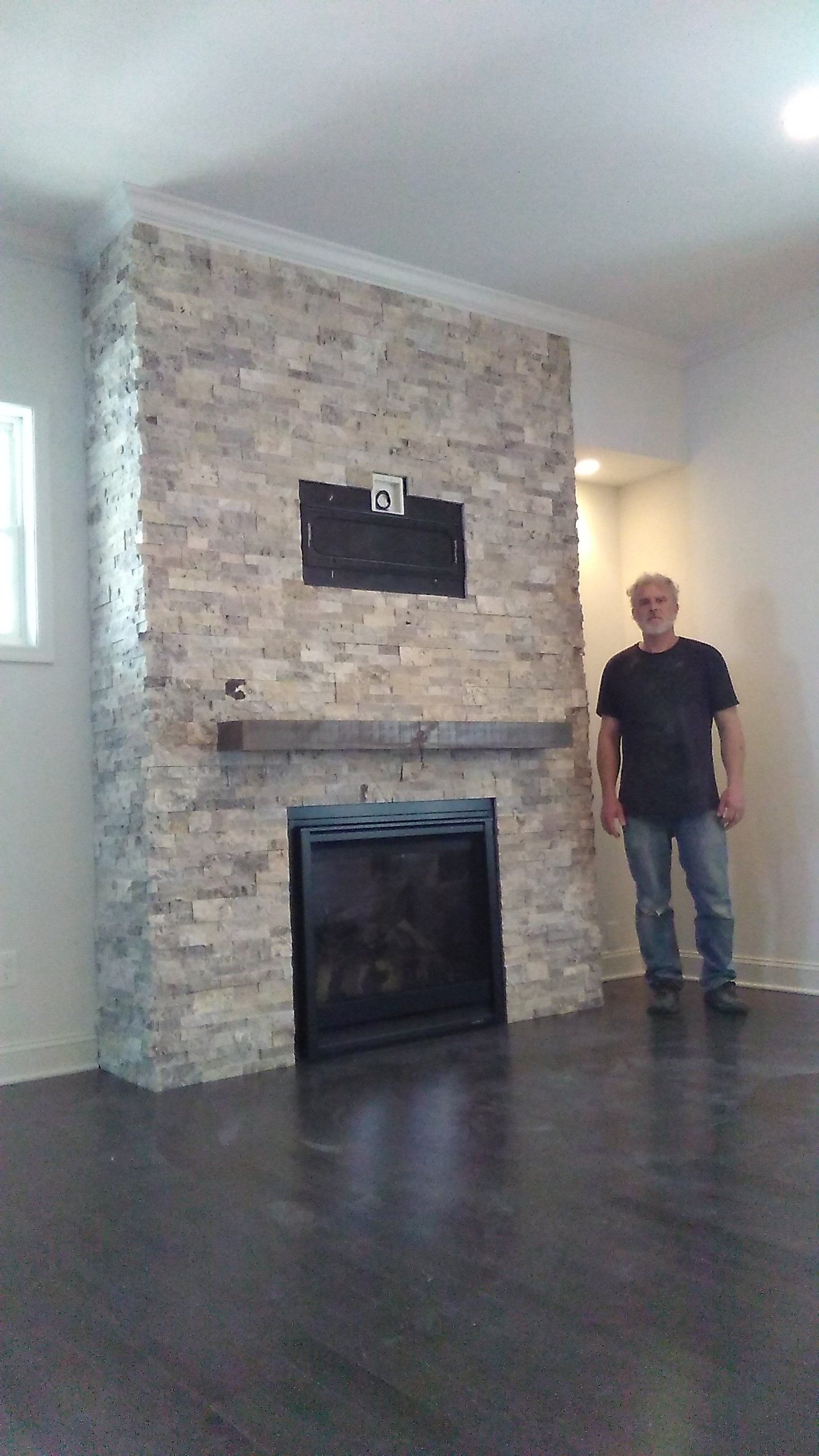 man by the stone fireplace